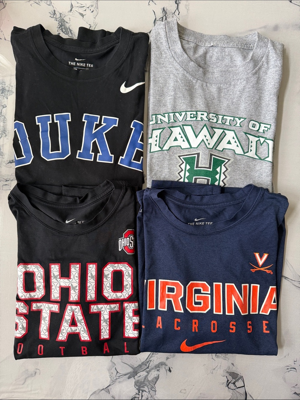 4 Nike college shirts . In very good condition .  Short sleeve